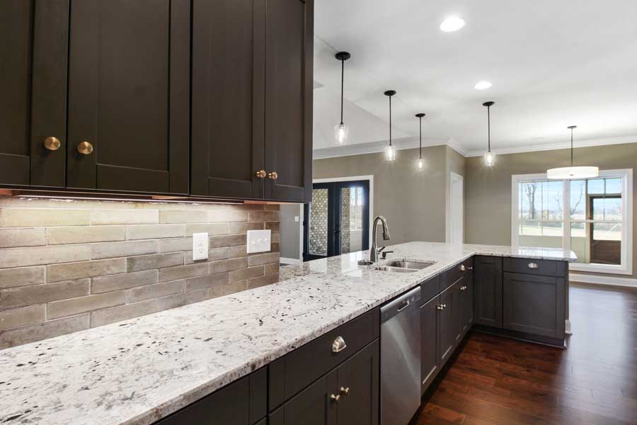 kitchen white spotted white and black granite countertops, a new sink and black cabinets