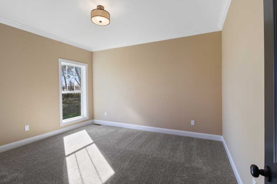 square bedroom with carpet